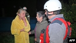 Ukrainian rescuers help residents of a damaged residential building after a drone strike on Kharkiv on the night of May 2-3.