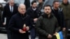 Ukrainian President Volodymyr Zelenskiy (right) and German Chancellor Olaf Scholz visit a makeshift memorial to fallen soldiers on Independence Square in Kyiv on December 2. 