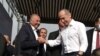 Prominent Armenian surgeon Armen Charchian (L) is being greeted by former President Robert Kocharian, leader of the opposition Hayastan alliance, during a rally in Yerevan, May 9, 2021.
