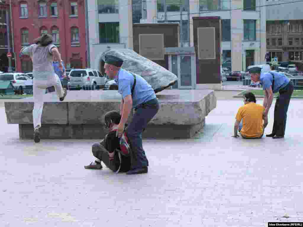 Police remove protesters from the Solovetsky Stone monument to victims of Soviet secret services in Moscow.