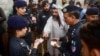 Pakistani police check the documents of Afghan refugees during a search operation to find illegal immigrants on the outskirts of Karachi. (file photo)