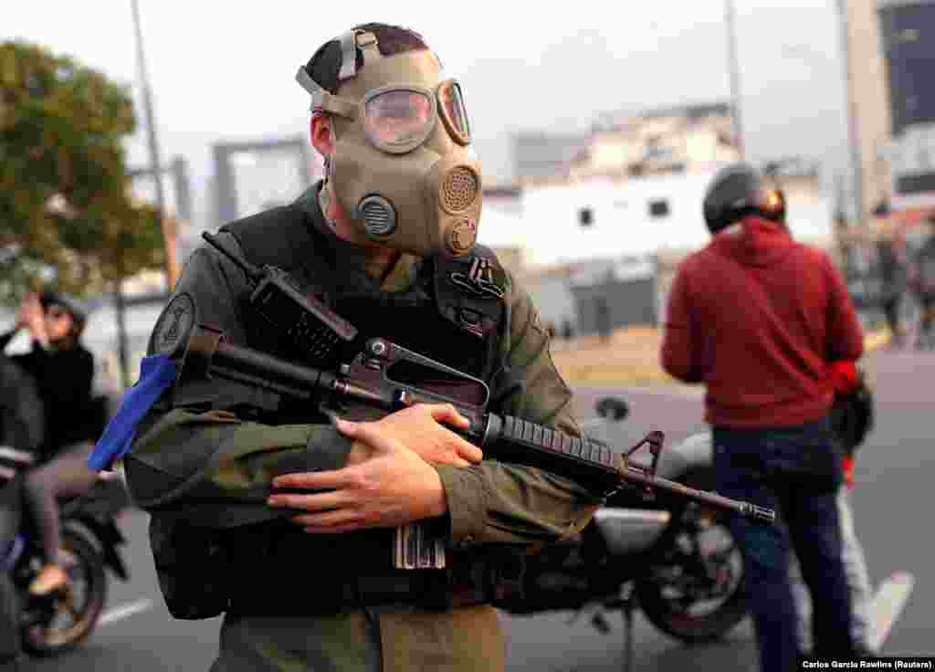 An armed man with a gas mask. According to Reuters, protests are planned for May 1, including what Guaido has said will be “the largest march in Venezuela’s history,” part of what he calls the “definitive phase” of his effort to take office in order to call fresh elections.