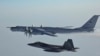A Russian Tu-142 maritime reconnaissance aircraft (top) is intercepted near the Alaska coastline. (file photo)